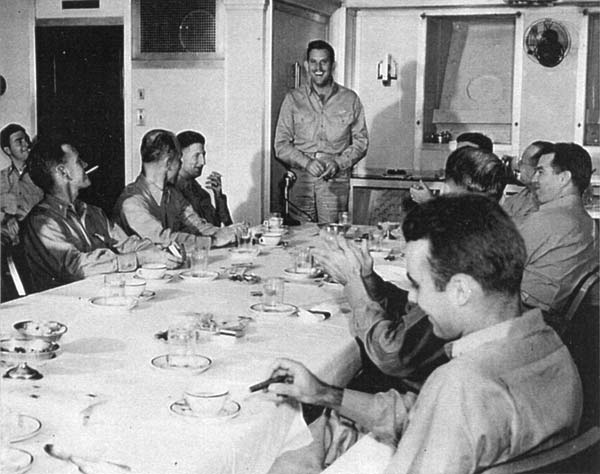 NAG-90 commander William I. Martin tells a story in Enterprise's wardroom, 24 December 1944.