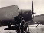 Flight deck crewmen tie down a NAG-90 plane just returned from a mission, 1945.