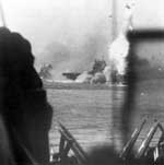 Enterprise CV-6 is hit by a Kamikaze, as seen from Essex CV-9, 14 May 1945.