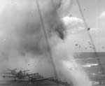 A Kamikaze explodes just off Enterprise's port quarter, 11 April 1945.