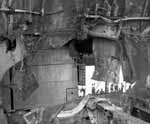 Enterprise's hangar deck interior seen through shattered No. 5 gun platform bulkhead.