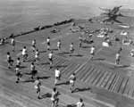 Enterprise CV-6 crewmen relax and exercise during the long voyage back to Pearl Harbor, May 1945.