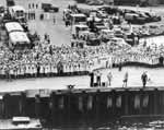 WAVES and others greet Enterprise CV-6 as she arrives in Pearl Harbor, 30 May 1945.