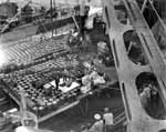 A 1000-lb bomb is transferred from Atascosa AO-66 to Enterprise CV-6, 4 September 1944.