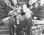 Ordnancemen aboard Enterprise CV-6 load TBM Avengers with fragmentation bombs, 10 October 1944.