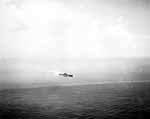 Aerial view of Enterprise CV-6 and escorts maneuvering sharply under attack, 26 October 1942.