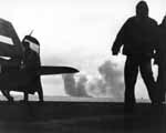 Crewmen aboard San Jacinto CVL-30 look on as Enterprise CV-6 fights fires, 20 March 1945.