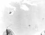 A Japanese dive bomber hurtles low over the Big E after releasing its bomb, 26 October 1942.