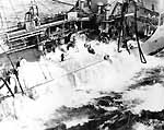 Oiler Kaskaskia AO-27's deck is awash as she refuels Enterprise CV-6 in heavy seas, 10 August 1942.