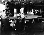 Aviation Metalsmiths aboard Enterprise CV-6 repair a broken wing tip, October 1941.