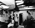 Sailors and Marines operate a tailoring shop aboard Enterprise CV-6, November 1941.