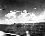 Spray rises from a near miss astern of Enterprise CV-6, 26 October 1942.