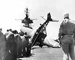 Flight deck crews prepare to right a crashed Fighting Ten F6F-3 Hellcat, 11 March 1944.