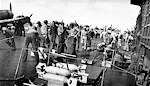 Crewmen wheel bombs to waiting planes on Enterprise CV-6, 1 February 1942.