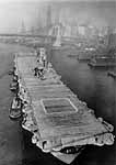 Enterprise CV-6 is pushed past the Brooklyn Bridge, 21 August 1958.