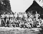 NAG-90 officers, beverages securely in hand, relax on Mog Mog island, Ulithi Atoll.