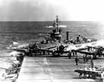 A destroyer passes close astern of Enterprise CV-6, as she sorties for the Doolittle Raid.