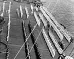 Captain Matthias Gardner inspects the men and officers of Enterprise, July 1944.