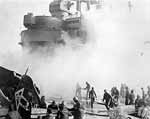 Enterprise CV-6 flight deck crews pull a damaged plane aside, 20 March 1945.