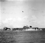 An enemy dive-bomber plummets towards USS Hornet CV-8, during the Battle of Santa Cruz.