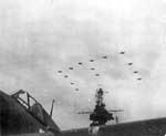 Ford Island planes welcome Enterprise CV-6 back to Pearl Harbor, 30 May 1945.