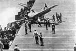 Crewman prepare to haul a runaway Grumman Wildcat aboard Enterprise CV-6, 26 October 1942.