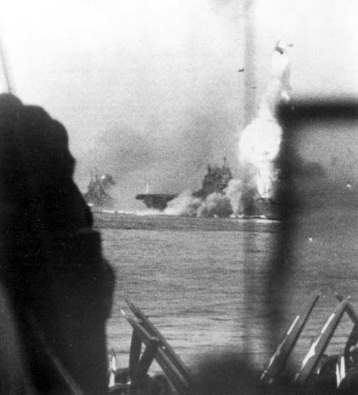 Enterprise CV-6 is hit by a Kamikaze, as seen from Essex CV-9, 14 May 1945.