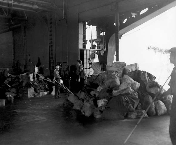 Bags of debris piled up in Enterprise's aft starboard boat pocket, following the Eastern Solomons.