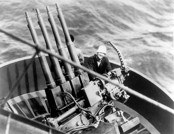 Gunner's Mate Vonzo Smith beside a quad 1.1" anti-aircraft mount aboard Enterprise in early 1942.