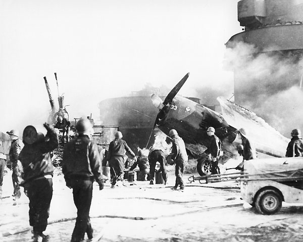 Damage-control teams fight fires fed by aviation fuel and ready ammunition, 20 March 1945.