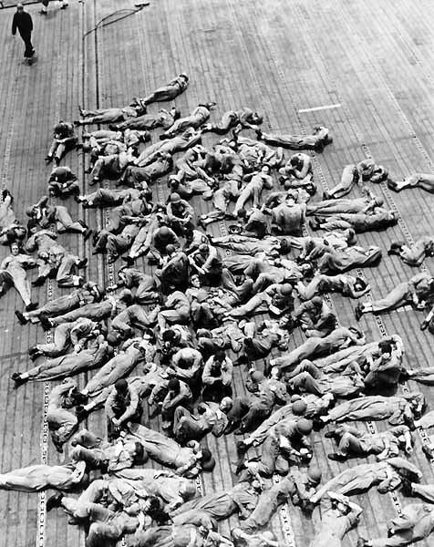 Flight deck crews on Enterprise CV-6 catch up on sleep, November 1942.