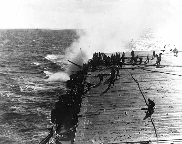 Damage control teams battle a fire in Enterprise CV-6's Group 3 5" gun gallery, 24 August 1942.