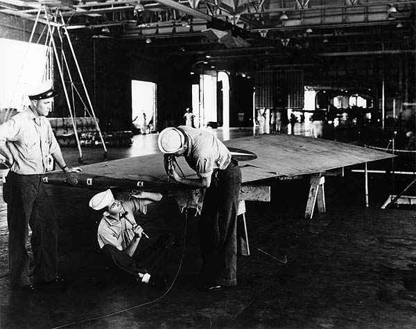 Aviation Metalsmiths aboard Enterprise CV-6 repair a broken wing tip, October 1941.