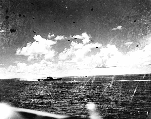 Spray rises from a near miss astern of Enterprise CV-6, 26 October 1942.