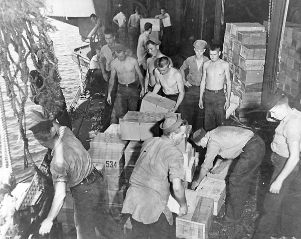 Men aboard Enterprise CV-6 load provisions in Majuro Harbor, following the February 1944 Truk raid.