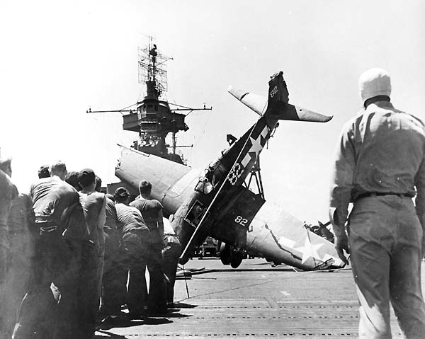 Flight deck crews prepare to right a crashed Fighting Ten F6F-3 Hellcat, 11 March 1944.