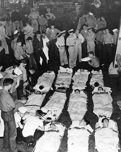 Wounded men await transfer in hangar deck of Enterprise CV-6, October 1942.