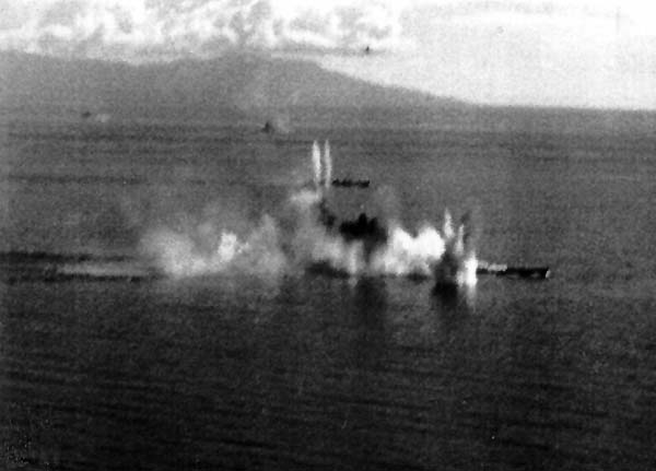 Japan's super-battleship Musashi is obscured by multiple bomb and torpedo hits, 24 October 1944.