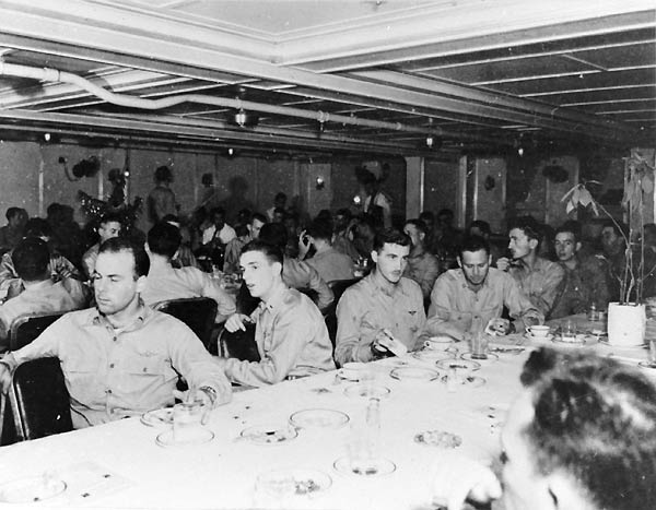 Officers relax in Enterprise's wardroom, 24 December 1944: Christmas Eve.