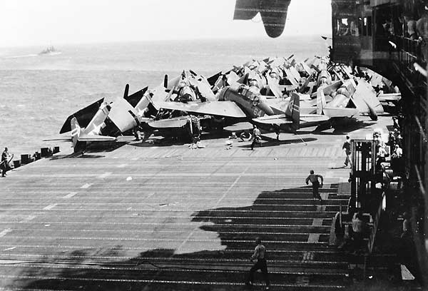 LT James "Casey" Moore's Avenger crashes into planes spotted forward on Enterprise's flight deck.