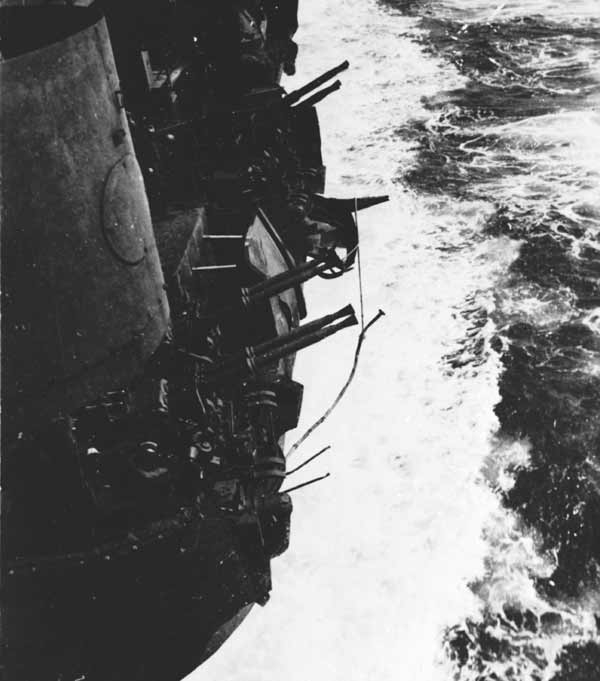 A crashing enemy plane sheared off the shields of two port-side 40mm gun platforms, 11 April 1945.