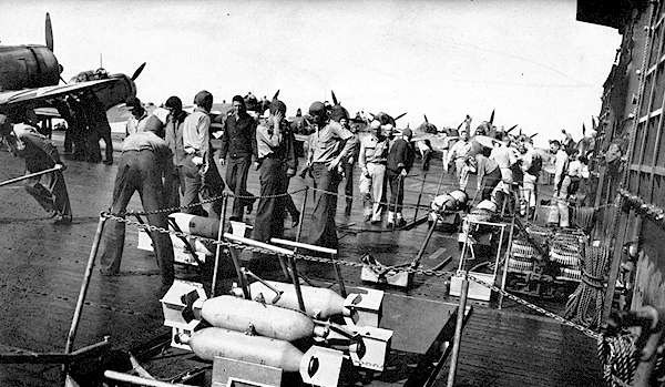 Crewmen wheel bombs to waiting planes on Enterprise CV-6, 1 February 1942.