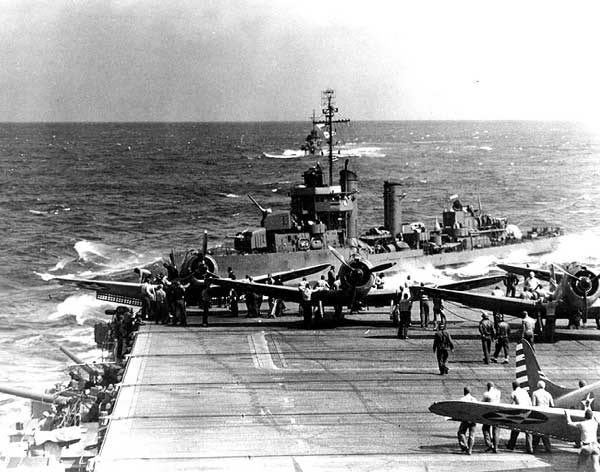 A destroyer passes close astern of Enterprise CV-6, as she sorties for the Doolittle Raid.