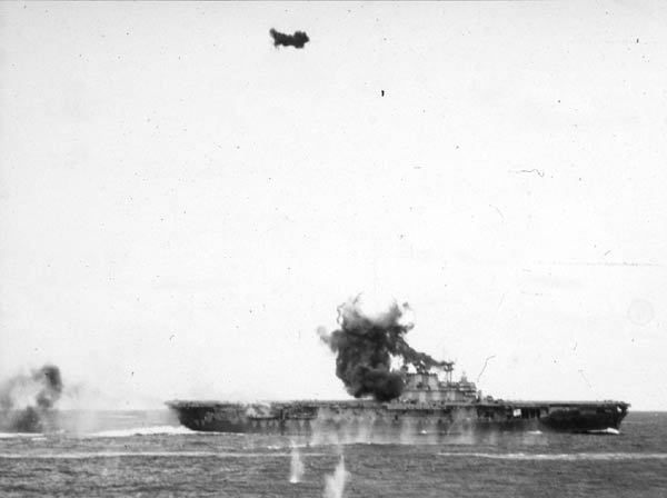 Smoke and flame boil from Hornet CV-8's island after she is crashed by a Japanese 'Val' dive bomber.