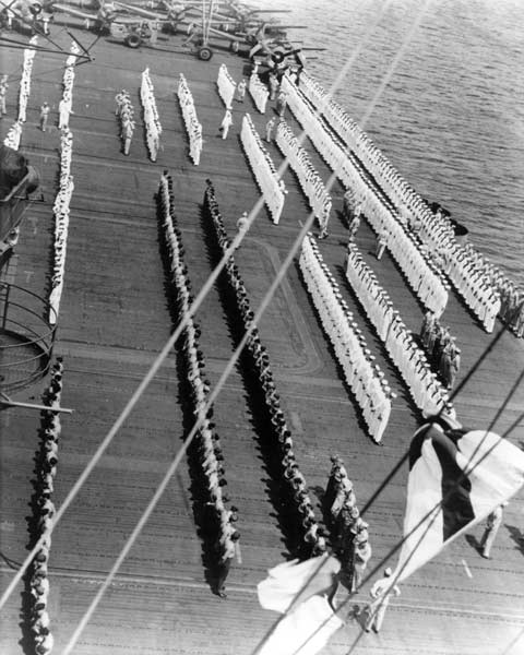 Captain Matthias Gardner inspects the men and officers of Enterprise, July 1944.