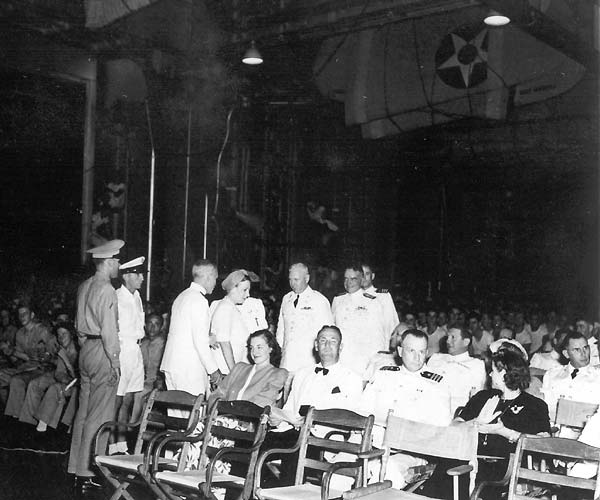 Vice Admiral Halsey and guests arrive for evening entertainment in Enterprise's hangar deck.