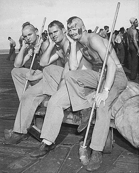 Three pollywogs sport new haircuts: Enterprise CV-6 Neptune Party, 19 September 1944.