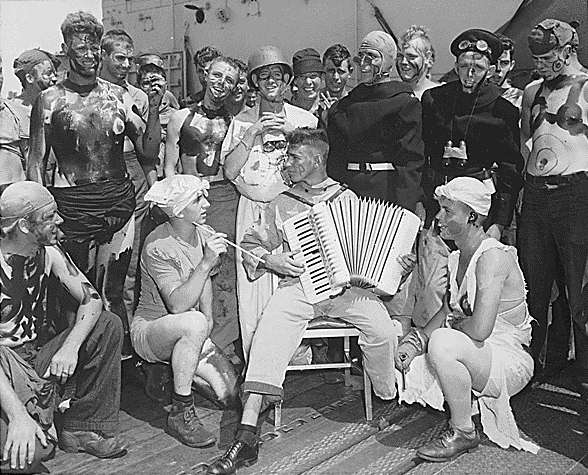 S 2/c V. E. Christensen and fellow Pollywogs during Enterprise's Neptune Party, 19 September 1944.