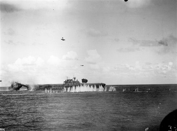 An enemy dive-bomber plummets towards USS Hornet CV-8, during the Battle of Santa Cruz.