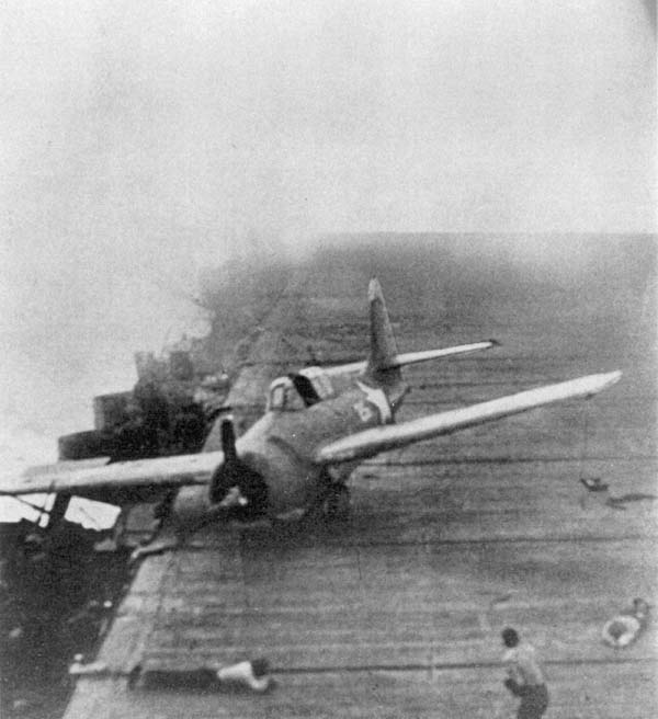 A plane wrenched from its moorings by a near miss skitters across the Big E's flight deck.